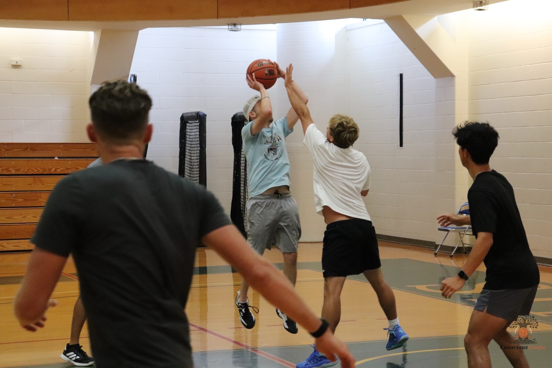 Players contest a jump shot during the first ConsciousHoops run