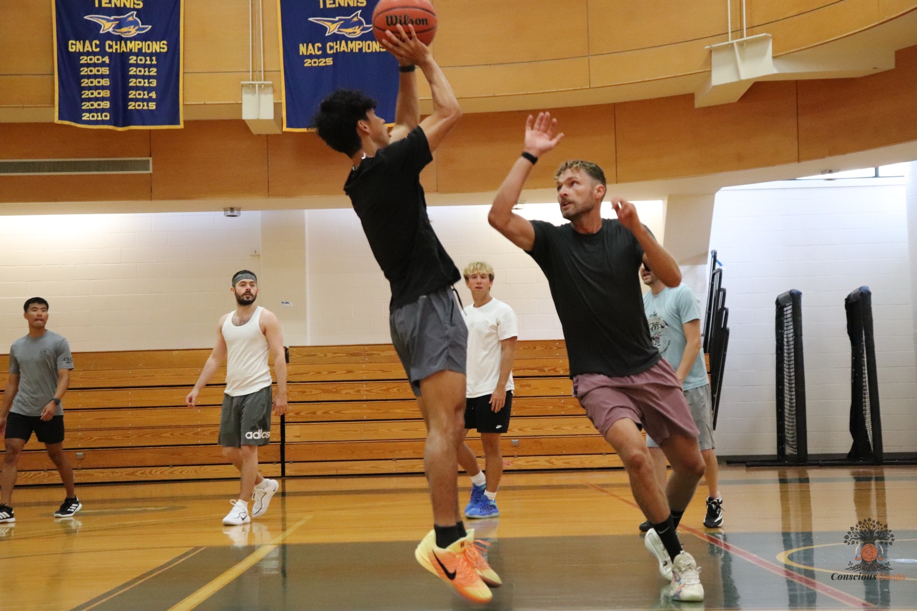 A player rises for a mid-range jumper with a defender closing out