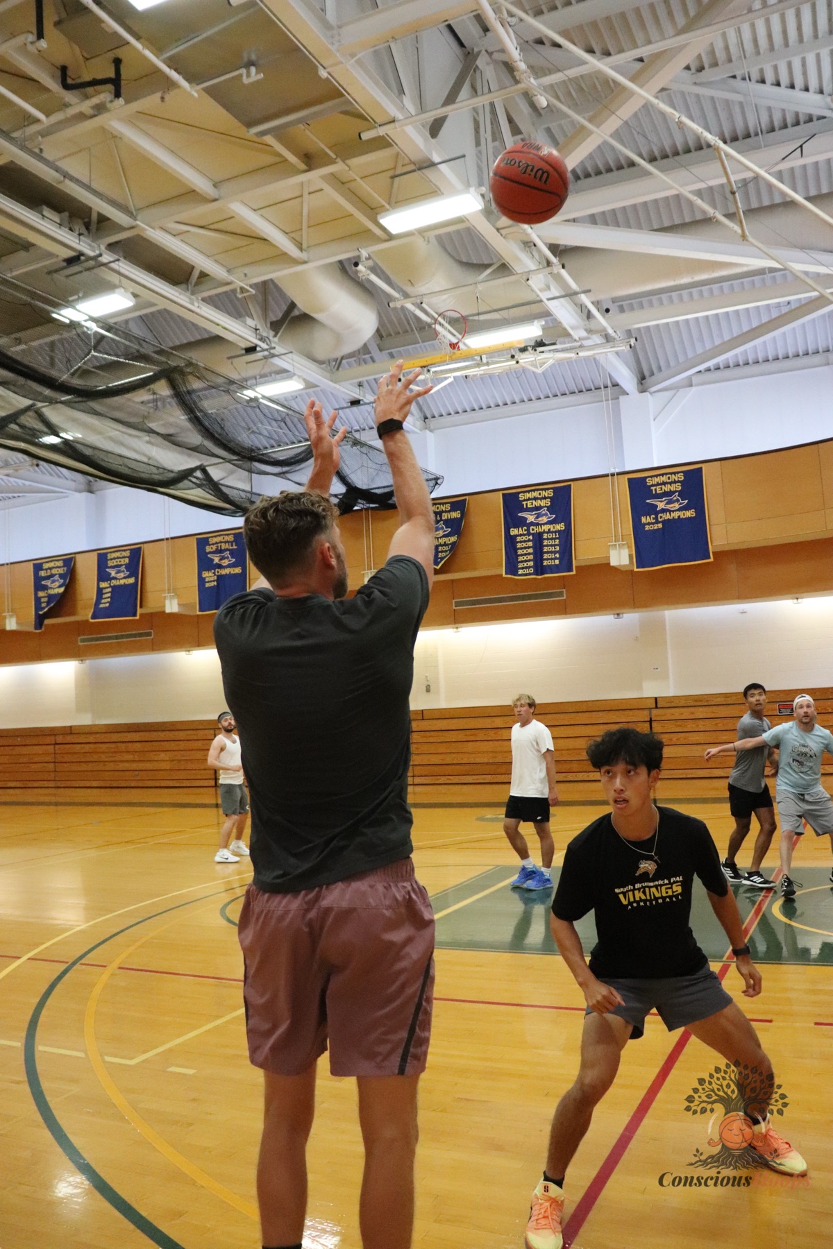 A shooter follows through as the ball floats toward the rim