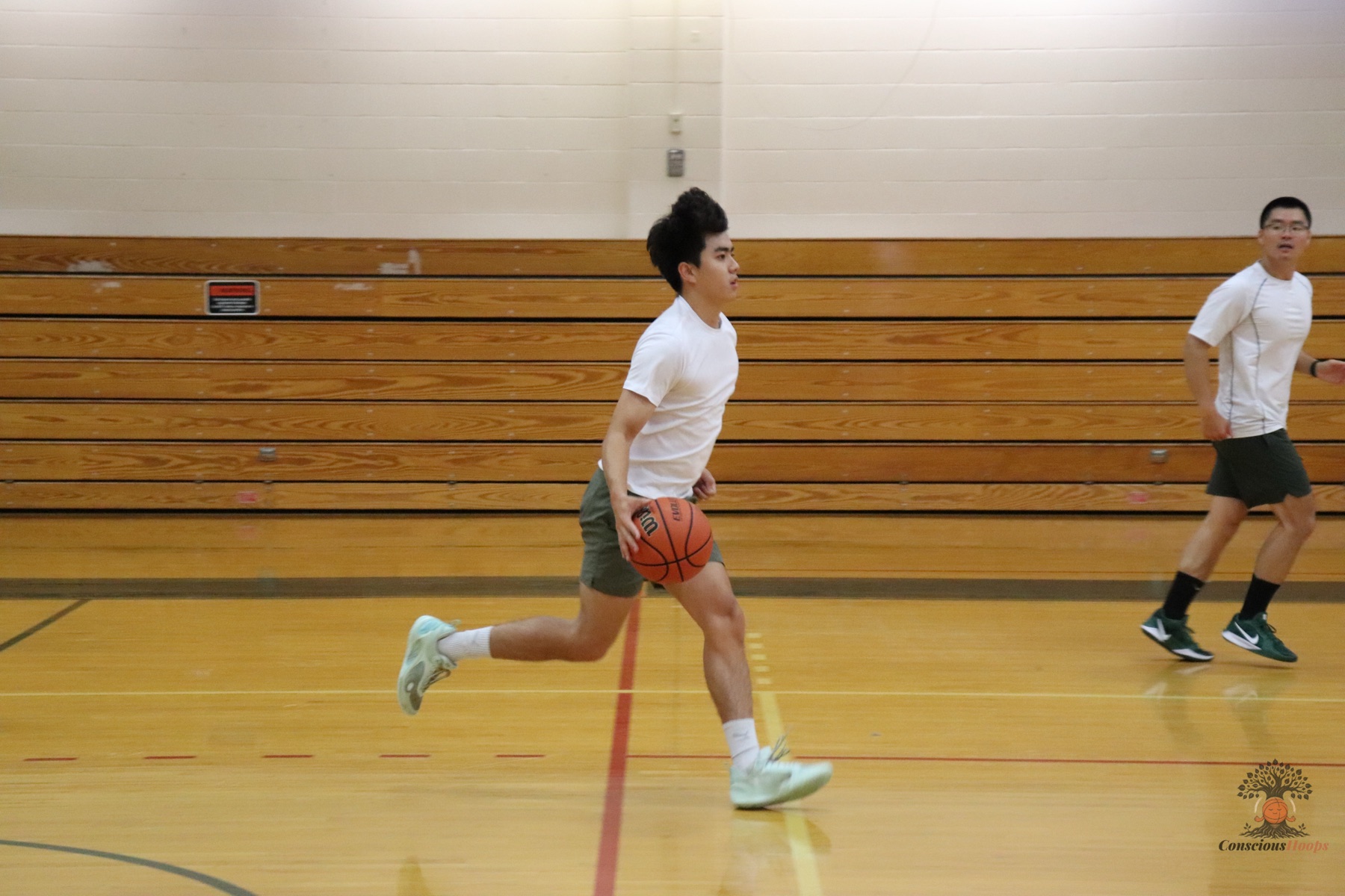 A player pushing the ball in transition down the court