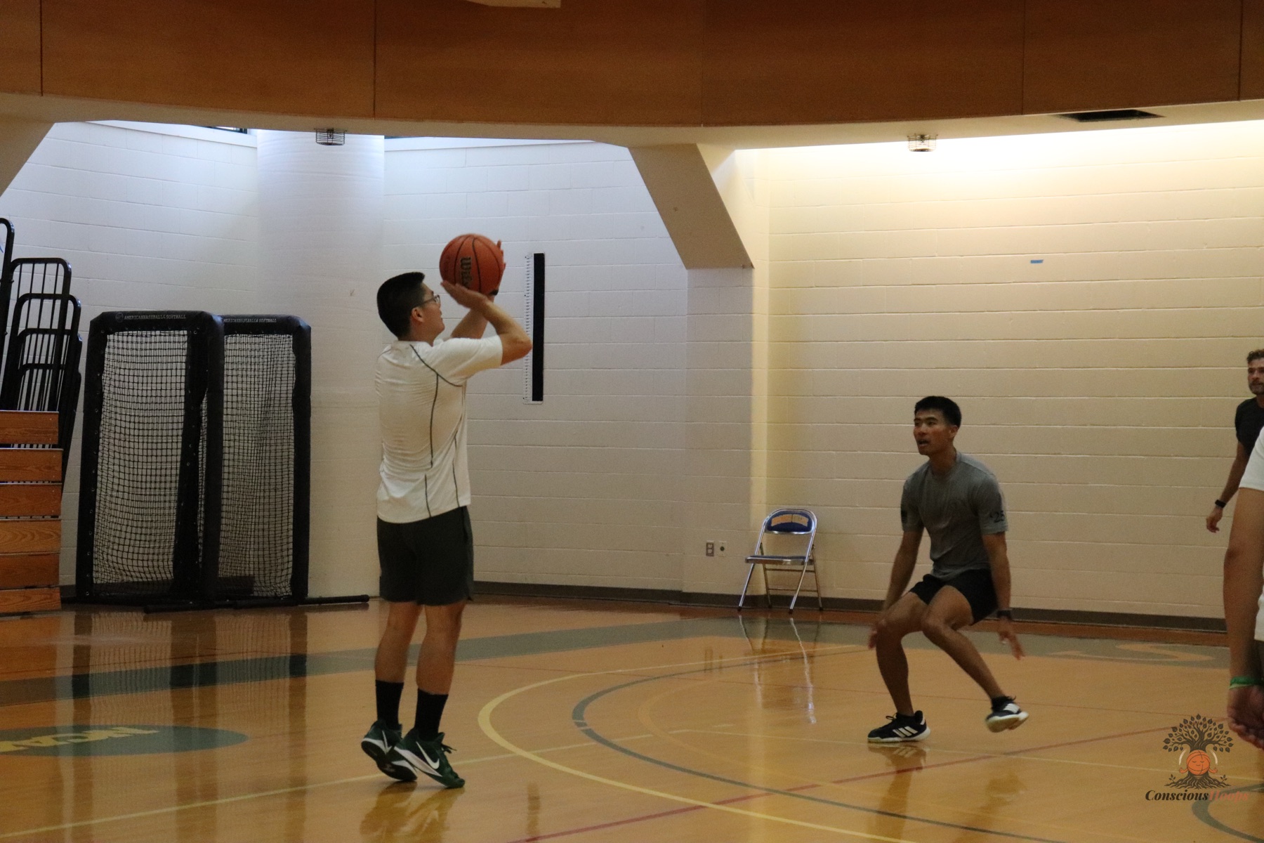 A player lines up a jump shot in a half-court set