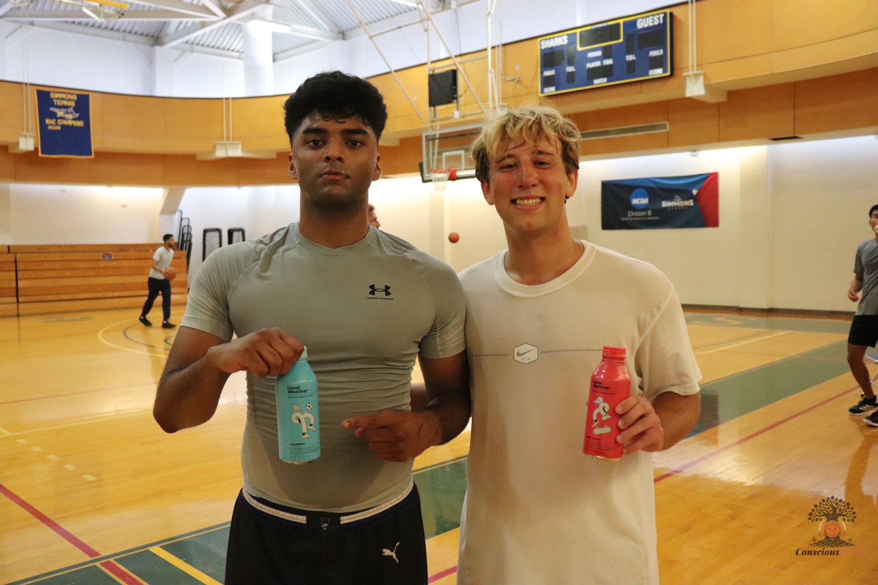 Two players smiling with Local Weather sports drinks after the run