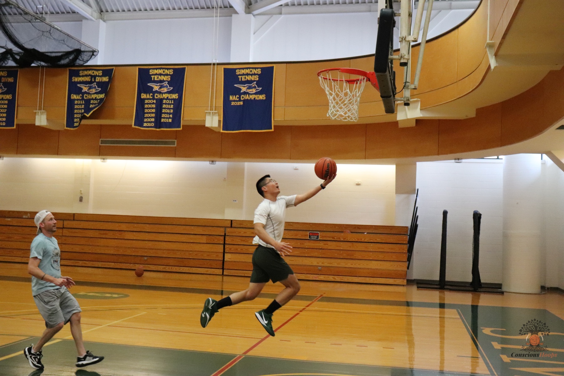 A player finishing a fast-break layup at the rim